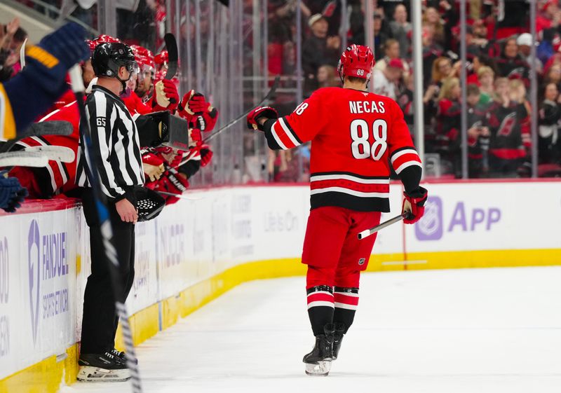 Nov 17, 2024; Raleigh, North Carolina, USA;  Carolina Hurricanes center Martin Necas (88) celebrates his goal against the St. Louis Blues during the third period at Lenovo Center. Mandatory Credit: James Guillory-Imagn Images