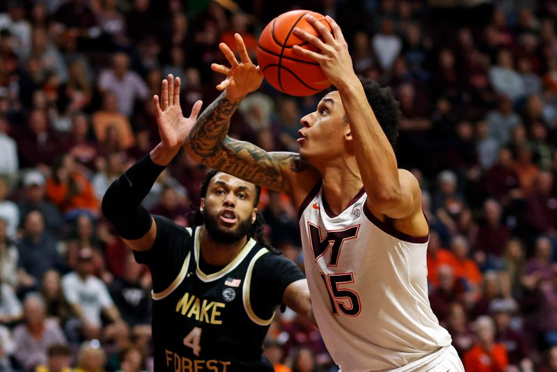 Mar 2, 2024; Blacksburg, Virginia, USA; Virginia Tech Hokies center Lynn Kidd (15) shoots the ball against Wake Forest Demon Deacons forward Efton Reid III (4) during the second half at Cassell Coliseum. Mandatory Credit: Peter Casey-USA TODAY Sports