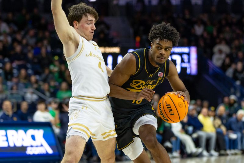 Dec 21, 2025; South Bend, Indiana, USA; Notre Dame Fighting Irish guard Jalen Haralson (10) drives against Purdue Fort Wayne Mastodons guard Chris Morgan (4) during the first half at Purcell Pavilion at the Joyce Center. Mandatory Credit: Michael Caterina-Imagn Images