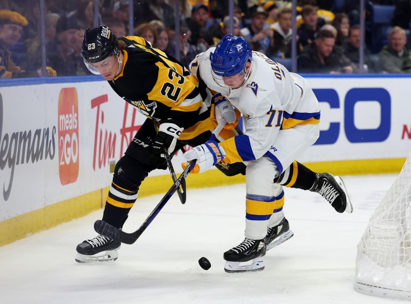 Dec 9, 2022; Buffalo, New York, USA;  Pittsburgh Penguins left wing Brock McGinn (23) and Buffalo Sabres left wing Victor Olofsson (71) go after a loose puck during the second period at KeyBank Center. Mandatory Credit: Timothy T. Ludwig-USA TODAY Sports