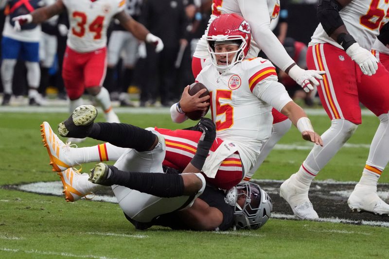 Kansas City Chiefs quarterback Patrick Mahomes (15) is sacked for a 10-yard loss by Las Vegas Raiders defensive end Tyree Wilson during the first half of an NFL football game Sunday, Oct. 27, 2024, in Las Vegas. (AP Photo/Rick Scuteri)