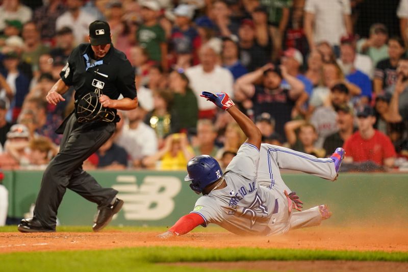 Aug 26, 2024; Boston, Massachusetts, USA; Toronto Blue Jays first baseman Vladimir Guerrero Jr. (27) scores on an error by the Boston Red Sox in the ninth inning at Fenway Park. Mandatory Credit: David Butler II-USA TODAY Sports