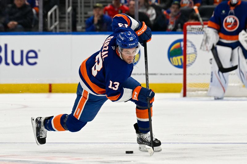 Nov 30, 2025; Elmont, New York, USA;  New York Islanders center Mathew Barzal (13) skates with the puck against the Washington Capitals during the second period at UBS Arena. Mandatory Credit: Dennis Schneidler-Imagn Images