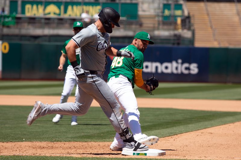 Aug 7, 2024; Oakland, California, USA; Chicago White Sox right fielder Gavin Sheets (32) beats the tag at first by Oakland Athletics pitcher T.J. McFarland (48) for an infield single during the seventh inning at Oakland-Alameda County Coliseum. Mandatory Credit: D. Ross Cameron-USA TODAY Sports