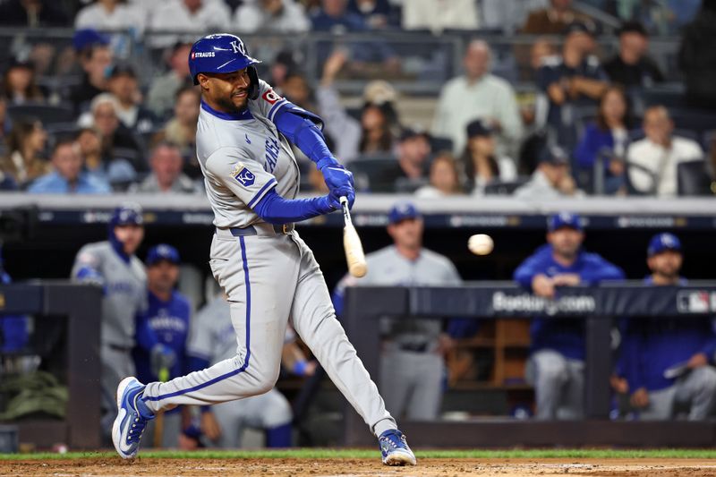 Oct 7, 2024; Bronx, New York, USA; Kansas City Royals third base Maikel Garcia (11) hits a single against the New York Yankees in the third inning during game two of the ALDS for the 2024 MLB Playoffs at Yankee Stadium. Mandatory Credit: Vincent Carchietta-Imagn Images