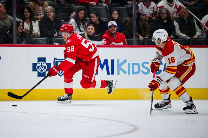 Mar 16, 2026; Detroit, Michigan, USA; Detroit Red Wings center Emmitt Finnie (58) brings the puck up ice against Calgary Flames center Morgan Frost (16) during the second period at Little Caesars Arena. Mandatory Credit: Tim Fuller-Imagn Images