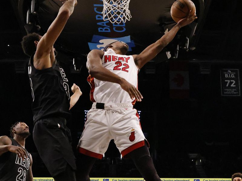 NEW YORK, NEW YORK - JANUARY 15:  Jimmy Butler #22 of the Miami Heat shoots against Nic Claxton #33 of the Brooklyn Nets during their game at Barclays Center on January 15, 2024 in New York City.   User expressly acknowledges and agrees that, by downloading and or using this photograph, User is consenting to the terms and conditions of the Getty Images License Agreement.  (Photo by Al Bello/Getty Images)