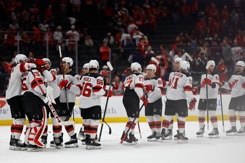 Oct 12, 2024; Washington, District of Columbia, USA; New Jersey Devils goaltender Jacob Markstrom (25) celebrates with teammates after their game against the Washington Capitals at Capital One Arena. Mandatory Credit: Geoff Burke-Imagn Images