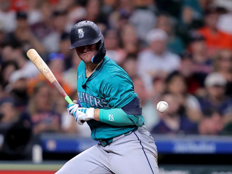 May 5, 2024; Houston, Texas, USA; Seattle Mariners first baseman Ty France (23) is hit by a pitch delivered by Houston Astros relief pitcher Seth Martinez (61, not shown) during the third inning at Minute Maid Park. Mandatory Credit: Erik Williams-USA TODAY Sports