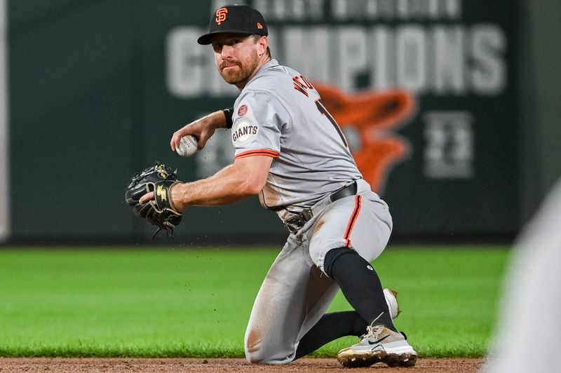 Sep 17, 2024; Baltimore, Maryland, USA;  San Francisco Giants second base Donovan Walton (18) throws to first base from his knees during the second inning against the Baltimore Orioles at Oriole Park at Camden Yards. Mandatory Credit: Tommy Gilligan-Imagn Images