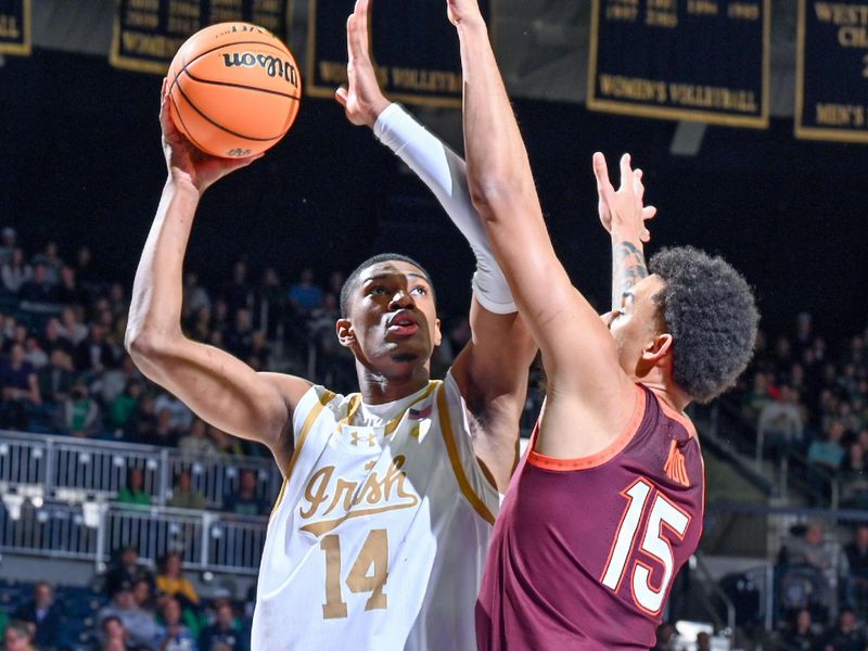 Feb 10, 2024; South Bend, Indiana, USA; Notre Dame Fighting Irish forward Kebba Njie (14) goes up for a shot as Virginia Tech Hokies center Lynn Kidd (15) defends in the first half at the Purcell Pavilion. Mandatory Credit: Matt Cashore-USA TODAY Sports