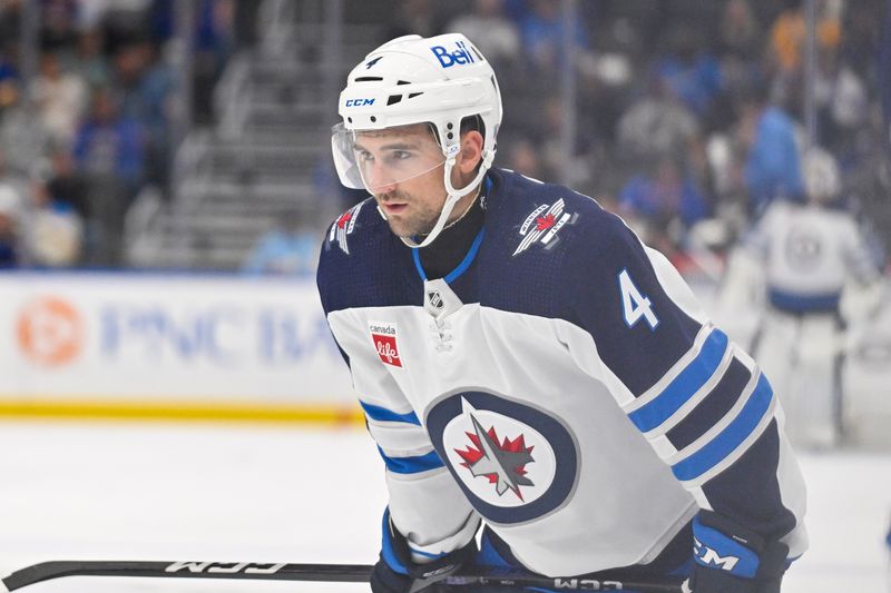 Nov 7, 2023; St. Louis, Missouri, USA;  Winnipeg Jets defenseman Neal Pionk (4) looks on during the third period against the St. Louis Blues at Enterprise Center. Mandatory Credit: Jeff Curry-USA TODAY Sports