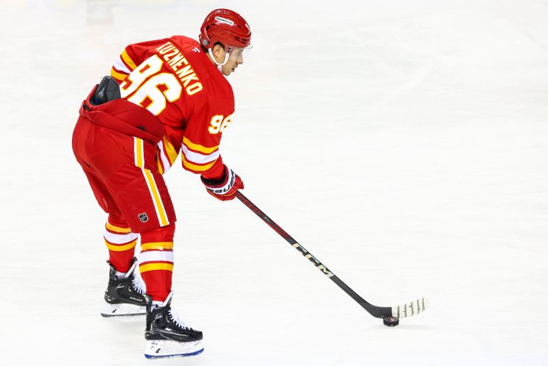 Nov 3, 2024; Calgary, Alberta, CAN; Calgary Flames left wing Andrei Kuzmenko (96) controls the puck during the warmup period against the Edmonton Oilers at Scotiabank Saddledome. Mandatory Credit: Sergei Belski-Imagn Images