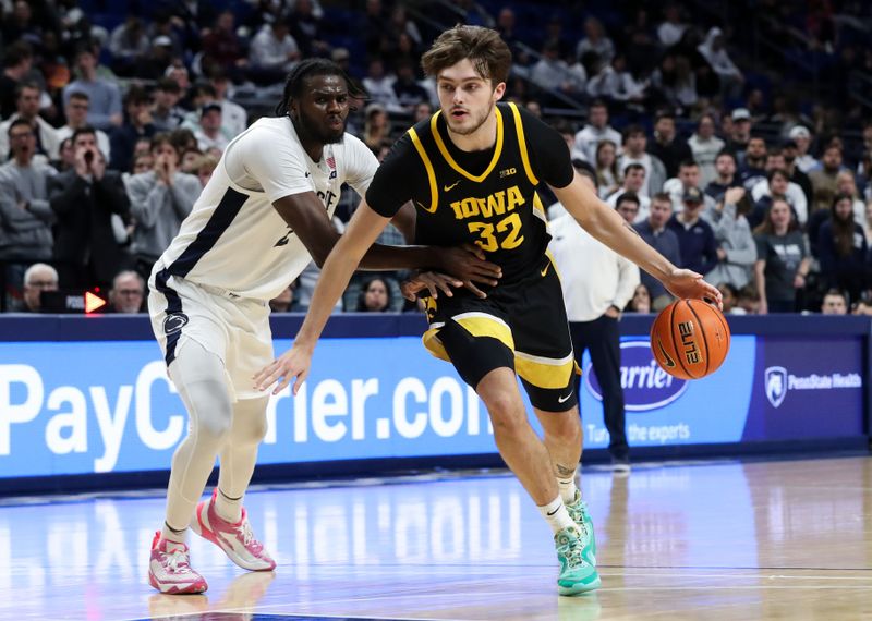 Feb 8, 2024; University Park, Pennsylvania, USA; Iowa Hawkeyes forward Owen Freeman (32) dribbles the ball around Penn State Nittany Lions forward Qudus Wahab (22) during the second half at Bryce Jordan Center. Penn State defeated Iowa 89-79. Mandatory Credit: Matthew O'Haren-USA TODAY Sports