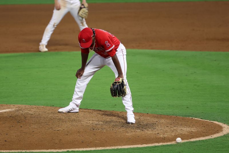 Sep 30, 2023; Anaheim, California, USA; Los Angeles Angels pitcher Jose Soriano (59) reacts after committing a balk with the bases loaded advancing Oakland Athletics center fielder Esteury Ruiz (1) and scoring the game tying run during the eighth inning at Angel Stadium. Mandatory Credit: Kiyoshi Mio-USA TODAY Sports