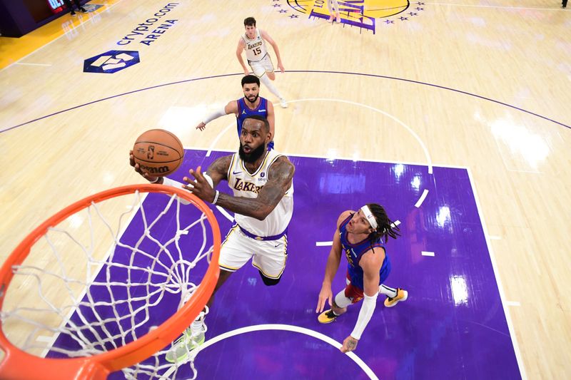 LOS ANGELES, CA - MARCH 2: LeBron James #23 of the Los Angeles Lakers drives to the basket during the game against the Denver Nuggets on March 2, 2024 at Crypto.Com Arena in Los Angeles, California. NOTE TO USER: User expressly acknowledges and agrees that, by downloading and/or using this Photograph, user is consenting to the terms and conditions of the Getty Images License Agreement. Mandatory Copyright Notice: Copyright 2024 NBAE (Photo by Adam Pantozzi/NBAE via Getty Images)