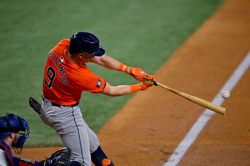 Aug 7, 2024; Arlington, Texas, USA;  Houston Astros first baseman Zach Dezenzo (9) hits a double against the Texas Rangers during the second inning at Globe Life Field. Mandatory Credit: Jerome Miron-USA TODAY Sports