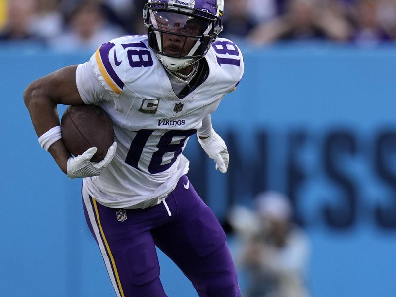 Minnesota Vikings wide receiver Justin Jefferson (18) tries to break a tackle by Tennessee Titans cornerback Jarvis Brownlee Jr. (29) during the second half of an NFL football game, Sunday, Nov. 17, 2024, in Nashville, Tenn. (AP Photo/George Walker IV)