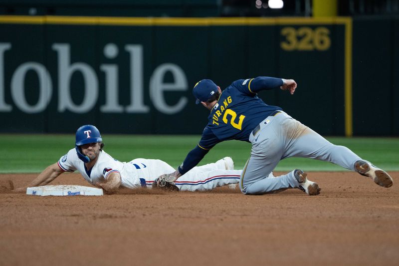 Sep 10, 2025; Arlington, Texas, USA; Texas Rangers shortstop Josh Smith (8) steals second base ahead of the tag by Milwaukee Brewers second baseman Brice Turang (2) during the fifth inning at Globe Life Field. Mandatory Credit: Jim Cowsert-Imagn Images
