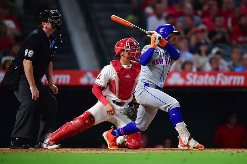 August 3, 2024; Anaheim, California, USA; New York Mets shortstop Francisco Lindor (12) hits a single against the Los Angeles Angels during the seventh inning at Angel Stadium. Mandatory Credit: Gary A. Vasquez-USA TODAY Sports