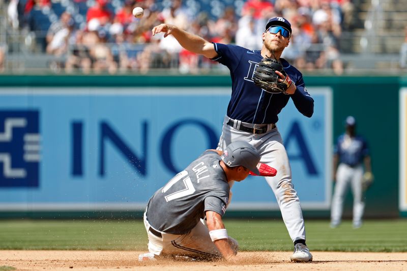 Apr 5, 2023; Washington, District of Columbia, USA; Tampa Bay Rays third baseman Taylor Walls (6) turns a double play at second base ahead of the slide of Washington Nationals left fielder Alex Call (17) during the fifth inning at Nationals Park. Mandatory Credit: Geoff Burke-USA TODAY Sports