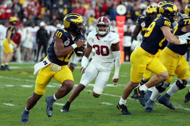 Jan 1, 2024; Pasadena, CA, USA; Michigan Wolverines quarterback Alex Orji (10) runs against the Alabama Crimson Tide in the third quarter in the 2024 Rose Bowl college football playoff semifinal game at Rose Bowl. Mandatory Credit: Kiyoshi Mio-USA TODAY Sports