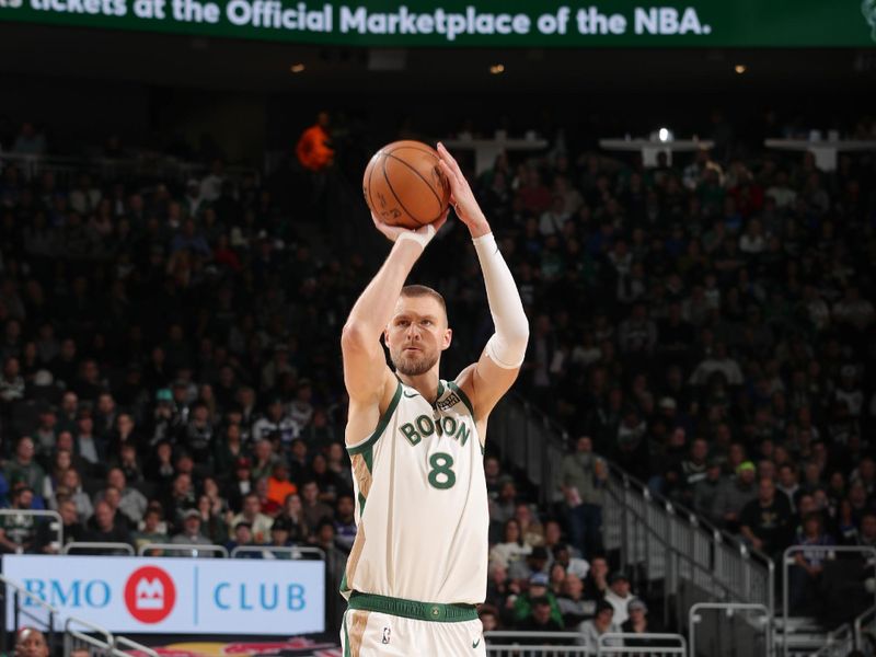 MILWAUKEE, WI - JANUARY 11: Kristaps Porzingis #8 of the Boston Celtics shoots a three point basket during the game  on January 11, 2024 at the Fiserv Forum Center in Milwaukee, Wisconsin. NOTE TO USER: User expressly acknowledges and agrees that, by downloading and or using this Photograph, user is consenting to the terms and conditions of the Getty Images License Agreement. Mandatory Copyright Notice: Copyright 2024 NBAE (Photo by Gary Dineen/NBAE via Getty Images).