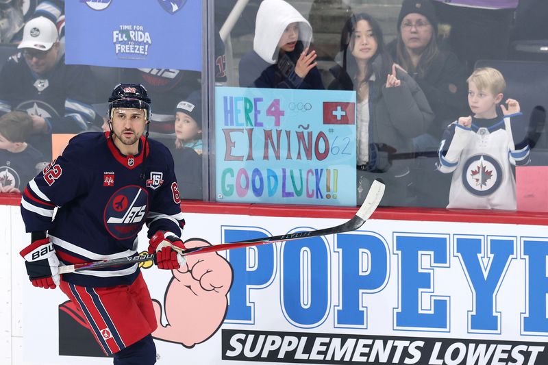 Jan 22, 2026; Winnipeg, Manitoba, CAN; Winnipeg Jets right wing Nino Niederreiter (62) skates past fans before a game against the Florida Panthers at Canada Life Centre. Mandatory Credit: James Carey Lauder-Imagn Images