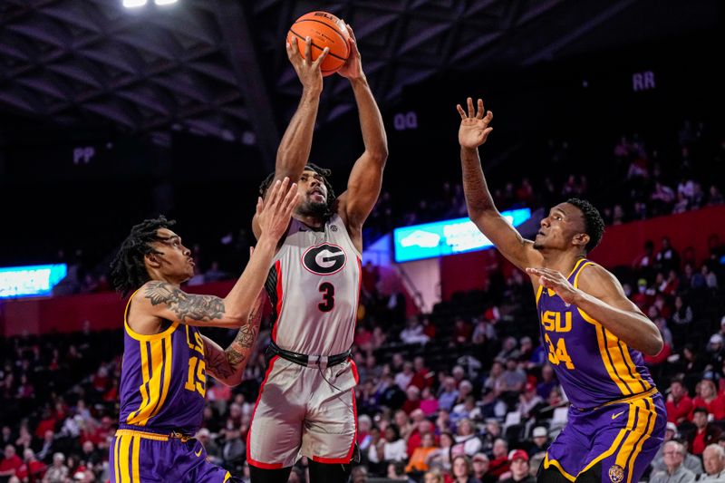 Feb 14, 2023; Athens, Georgia, USA; Georgia Bulldogs guard Kario Oquendo (3) shoots between LSU Tigers forward Tyrell Ward (15) and forward Shawn Phillips (34) during the second half at Stegeman Coliseum. Mandatory Credit: Dale Zanine-USA TODAY Sports