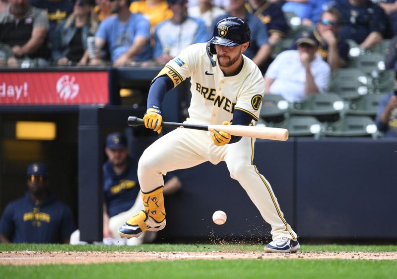May 1, 2024; Milwaukee, Wisconsin, USA; Milwaukee Brewers second base Brice Turang (2) bunts against the Tampa Bay Rays in the fifth inning at American Family Field. Mandatory Credit: Michael McLoone-USA TODAY Sports