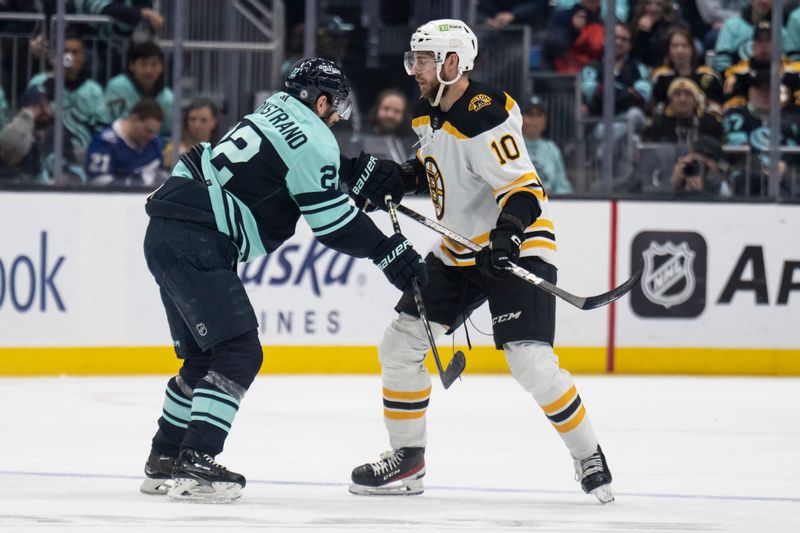 Feb 23, 2023; Seattle, Washington, USA; Seattle Kraken forward Oliver Bjorkstrand (22) and Boston Bruins forward A.J. Greer (10) scuffle during the second period at Climate Pledge Arena. Mandatory Credit: Stephen Brashear-USA TODAY Sports