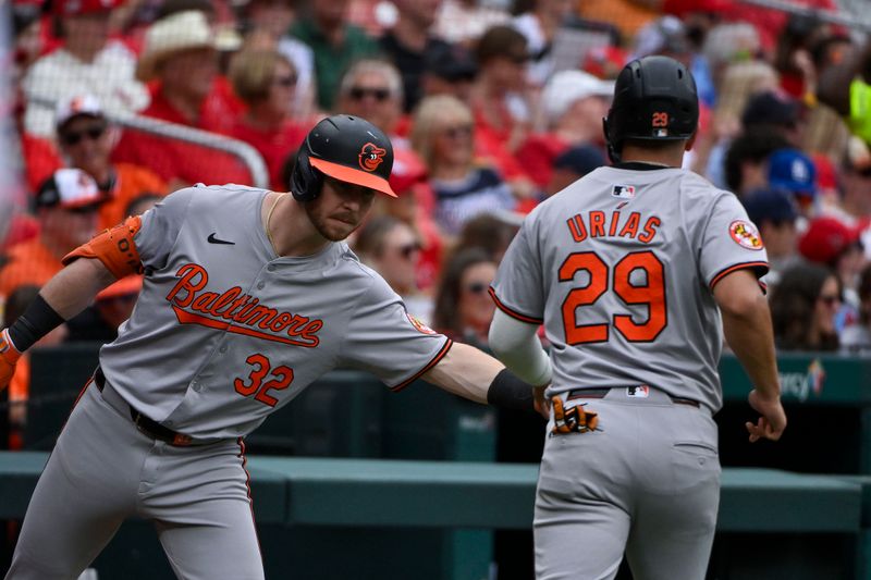 May 22, 2024; St. Louis, Missouri, USA;  Baltimore Orioles first baseman Ryan O'Hearn (32) congratulates third baseman Ramon Urias (29) after he scored against the St. Louis Cardinals during the third inningat Busch Stadium. Mandatory Credit: Jeff Curry-USA TODAY Sports