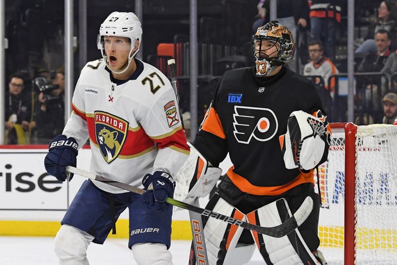 Jan 13, 2025; Philadelphia, Pennsylvania, USA; Florida Panthers center Eetu Luostarinen (27) stands in front of Philadelphia Flyers goaltender Samuel Ersson (33) during the second period at Wells Fargo Center. Mandatory Credit: Eric Hartline-Imagn Images