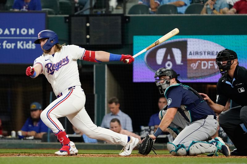 Apr 25, 2024; Arlington, Texas, USA; Texas Rangers third base Davis Wendzel (38) gets is his first major league hit during the eighth inning against the Seattle Mariners at Globe Life Field. Mandatory Credit: Raymond Carlin III-USA TODAY Sports