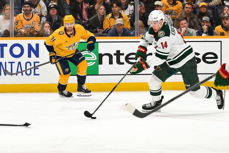 Feb 4, 2026; Nashville, Tennessee, USA;  Minnesota Wild center Joel Eriksson Ek (14) clears the puck against the Nashville Predators during the third period at Bridgestone Arena. Mandatory Credit: Steve Roberts-Imagn Images