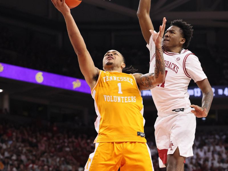 Jan 3, 2026; Fayetteville, Arkansas, USA; Tennessee Volunteers guard Amari Evans (1) shoots in the first half as Arkansas Razorbacks wing Karter Knox (11) defends at Bud Walton Arena. Mandatory Credit: Nelson Chenault-Imagn Images