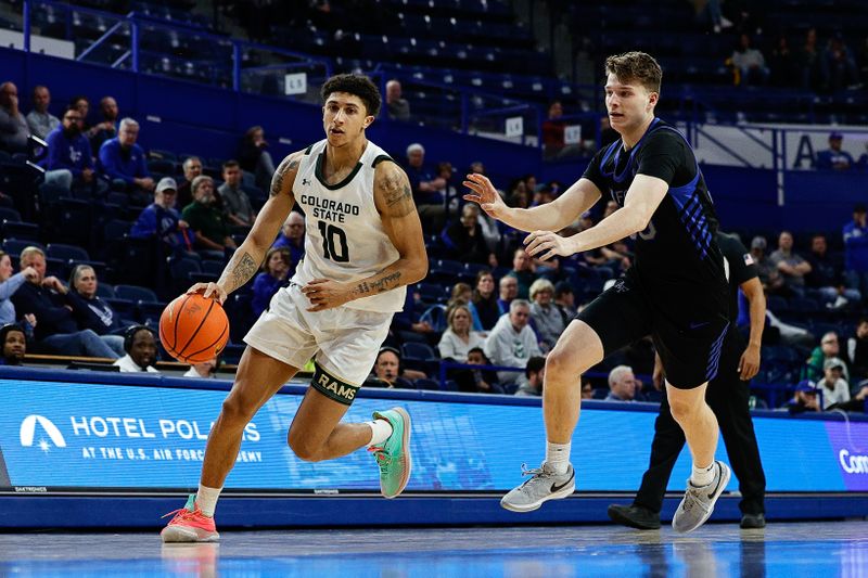 Feb 25, 2025; Colorado Springs, Colorado, USA; Colorado State Rams guard Nique Clifford (10) controls the ball against Air Force Falcons forward Eli Robinson (30) in the second half at Clune Arena. Mandatory Credit: Isaiah J. Downing-Imagn Images