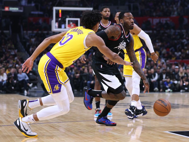 LOS ANGELES, CALIFORNIA - NOVEMBER 09: John Wall #11 of the LA Clippers drives to the basket on Max Christie #10 of the Los Angeles Lakers during a 114-101 Clippers win at Crypto.com Arena on November 09, 2022 in Los Angeles, California. NOTE TO USER: User expressly acknowledges and agrees that, by downloading and or using this Photograph, User is consenting to the terms and conditions of the Getty Images License Agreement. Mandatory Copyright Notice: Copyright 2022 NBAE. (Photo by Harry How/Getty Images)