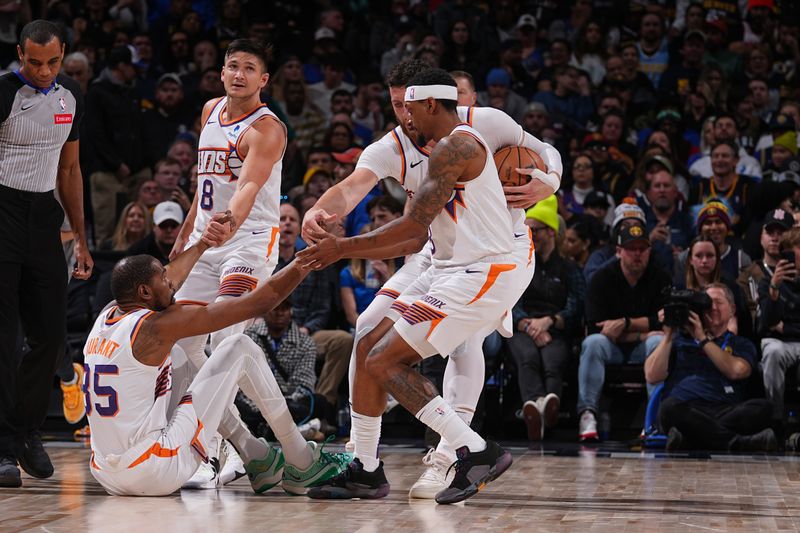 DENVER, CO - MARCH 5: Kevin Durant #35 of the Phoenix Suns is helped up by Grayson Allen #8, Bradley Beal #3 and Jusuf Nurkic #20 during the game against the Denver Nuggets on March 5, 2024 at the Ball Arena in Denver, Colorado. NOTE TO USER: User expressly acknowledges and agrees that, by downloading and/or using this Photograph, user is consenting to the terms and conditions of the Getty Images License Agreement. Mandatory Copyright Notice: Copyright 2024 NBAE (Photo by Bart Young/NBAE via Getty Images)