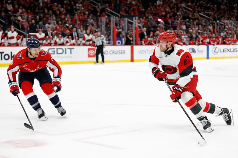 Dec 11, 2025; Washington, District of Columbia, USA; Carolina Hurricanes left wing Nikolaj Ehlers (27) skates with the puck as Washington Capitals defenseman Jakob Chychrun (6) chases in overtime at Capital One Arena. Mandatory Credit: Geoff Burke-Imagn Images
