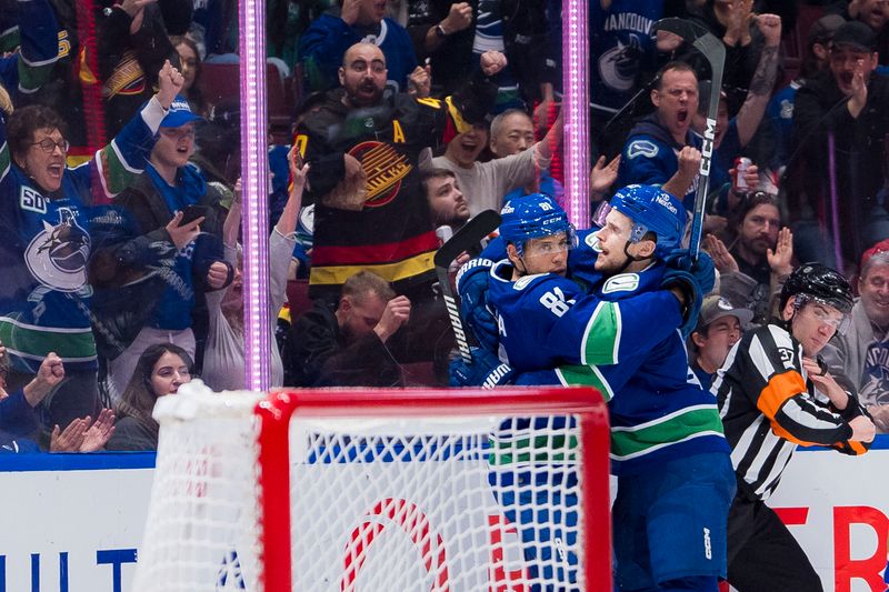 Dec 28, 2023; Vancouver, British Columbia, CAN; Vancouver Canucks forward Dakota Joshua (81) and forward Teddy Blueger (53) celebrate Blueger   s goal against the Philadelphia Flyers in the third period at Rogers Arena. Flyers won 4-1. Mandatory Credit: Bob Frid-USA TODAY Sports