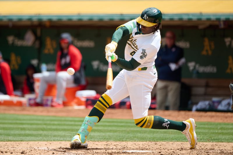 Apr 14, 2024; Oakland, California, USA; Oakland Athletics outfielder Lawrence Butler (4) hits a double against the Washington Nationals during the fifth inning at Oakland-Alameda County Coliseum. Mandatory Credit: Robert Edwards-USA TODAY Sports