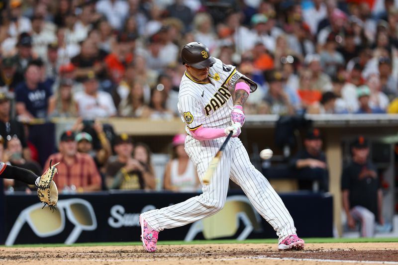 Sep 7, 2024; San Diego, California, USA; San Diego Padres third baseman Manny Machado (13) singles against the San Francisco Giants in the fifth inning at Petco Park. Mandatory Credit: Chadd Cady-Imagn Images