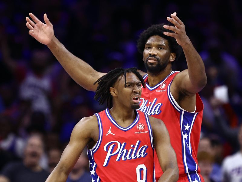 PHILADELPHIA, PENNSYLVANIA - APRIL 28: Tyrese Maxey #0 and Joel Embiid #21 of the Philadelphia 76ers react during the first quarter against the New York Knicks during game four of the Eastern Conference First Round Playoffs at the Wells Fargo Center on April 28, 2024 in Philadelphia, Pennsylvania. NOTE TO USER: User expressly acknowledges and agrees that, by downloading and/or using this Photograph, user is consenting to the terms and conditions of the Getty Images License Agreement. (Photo by Tim Nwachukwu/Getty Images)