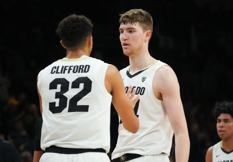 Mar 4, 2023; Boulder, Colorado, USA; Colorado Buffaloes center Lawson Lovering (34) and guard Nique Clifford (32) celebrate a play in the first half at the CU Events Center. Mandatory Credit: Ron Chenoy-USA TODAY Sports