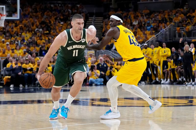 INDIANAPOLIS, INDIANA - APRIL 26: Brook Lopez #11 of the Milwaukee Bucks dribbles the ball while being guarded by Pascal Siakam #43 of the Indiana Pacers in the second quarter during game three of the Eastern Conference First Round Playoffs at Gainbridge Fieldhouse on April 26, 2024 in Indianapolis, Indiana. NOTE TO USER: User expressly acknowledges and agrees that, by downloading and or using this photograph, User is consenting to the terms and conditions of the Getty Images License Agreement. (Photo by Dylan Buell/Getty Images)