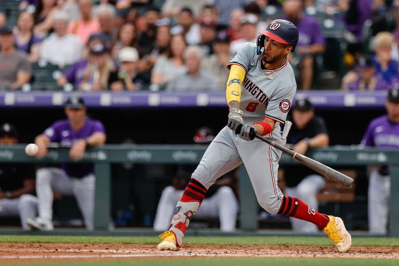 Jun 21, 2024; Denver, Colorado, USA; Washington Nationals designated hitter Eddie Rosario (8) hits an RBI double in the third inning against the Colorado Rockies at Coors Field. Mandatory Credit: Isaiah J. Downing-USA TODAY Sports