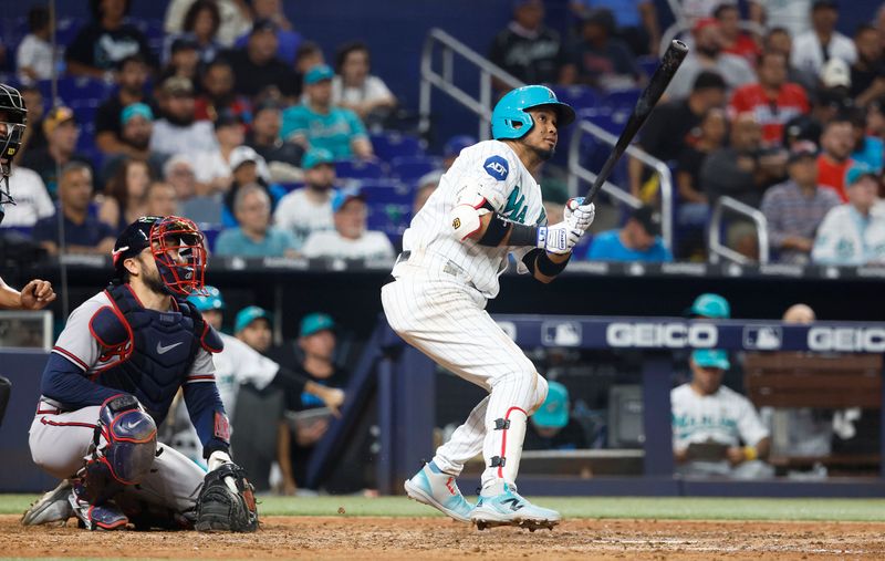 Sep 15, 2023; Miami, Florida, USA; Miami Marlins second baseman Luis Arraez (3) hits a home run against the Atlanta Braves during the seventh inning at loanDepot Park. Mandatory Credit: Rhona Wise-USA TODAY Sports