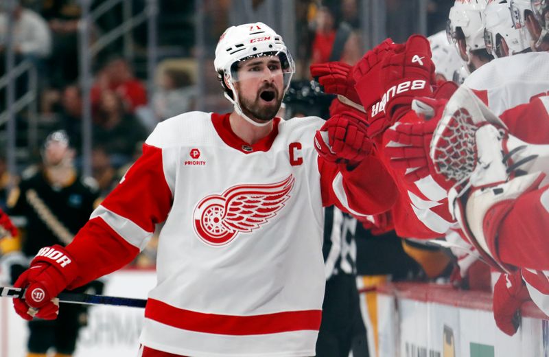 Apr 11, 2024; Pittsburgh, Pennsylvania, USA; Detroit Red Wings center Dylan Larkin (71) celebrates with the Red Wings bench after scoring a goal against the Pittsburgh Penguins during the third period at PPG Paints Arena. Pittsburgh won 6-5 in overtime. Mandatory Credit: Charles LeClaire-USA TODAY Sports