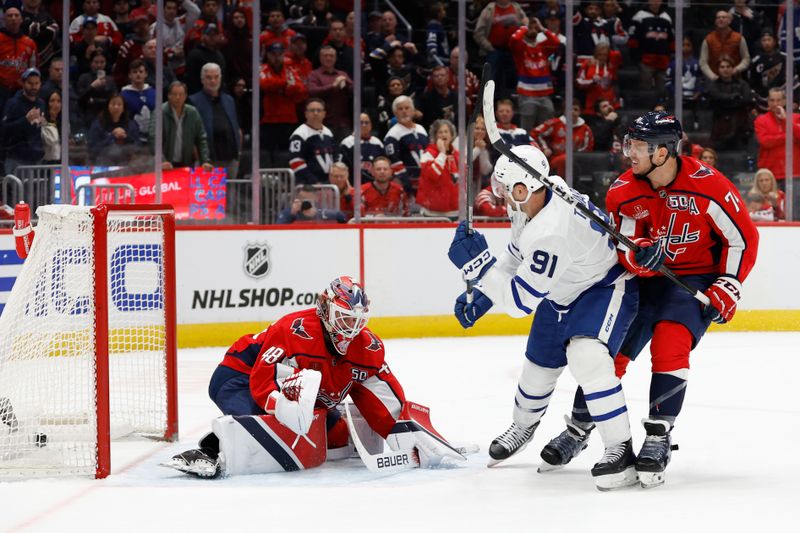 Nov 13, 2024; Washington, District of Columbia, USA; Toronto Maple Leafs center John Tavares (91) scores the game winning overtime goal on Washington Capitals goaltender Logan Thompson (48) as Capitals defenseman John Carlson (74) defends at Capital One Arena. Mandatory Credit: Geoff Burke-Imagn Images